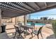 Relaxing poolside patio area with outdoor dining set and a view of the community pool in a covered seating arrangement at 1245 E Avenida Hermosa --, Phoenix, AZ 85014