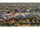 Aerial view showing a ranch house in a neighborhood with mature trees and golf course views at 12734 W Crystal Lake Dr, Sun City West, AZ 85375