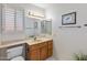 Clean bathroom featuring a single vanity, toilet, and window at 12734 W Crystal Lake Dr, Sun City West, AZ 85375