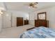 Spacious bedroom with wood furniture, large windows, and ceiling fan at 12734 W Crystal Lake Dr, Sun City West, AZ 85375