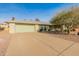 House exterior featuring a light green single story home with a two car garage and a neatly landscaped yard at 12734 W Crystal Lake Dr, Sun City West, AZ 85375