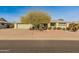 House exterior showcasing a single story home with a light green facade and desert landscaping at 12734 W Crystal Lake Dr, Sun City West, AZ 85375