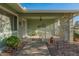 Inviting front porch with wrought iron gate and small patio furniture, ideal for relaxing outdoors at 12734 W Crystal Lake Dr, Sun City West, AZ 85375