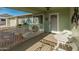 Covered front porch with a white table and chairs, providing a shaded seating area at 12734 W Crystal Lake Dr, Sun City West, AZ 85375