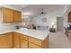 Open kitchen features a breakfast bar and views into the living room at 12734 W Crystal Lake Dr, Sun City West, AZ 85375