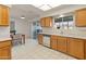 Galley-style kitchen with wood cabinets and tiled floors at 12734 W Crystal Lake Dr, Sun City West, AZ 85375