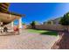 Home features a backyard with artificial turf, covered patio, and brick pavers at 12791 W Caraveo Pl, Peoria, AZ 85383