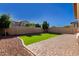 Artificial turf and brick pavers create a low-maintenance backyard space at 12791 W Caraveo Pl, Peoria, AZ 85383