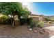 Single-story home with stone and red accents, and landscaped front yard at 12791 W Caraveo Pl, Peoria, AZ 85383