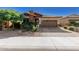 Single-story home with stone and red accents, brown garage door, and landscaped front yard at 12791 W Caraveo Pl, Peoria, AZ 85383