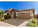 Single-story home with stone and red accents, brown garage door, and landscaped front yard at 12791 W Caraveo Pl, Peoria, AZ 85383