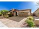 Single-story home with stone and red accents, brown garage door, and landscaped front yard at 12791 W Caraveo Pl, Peoria, AZ 85383