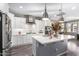 Modern kitchen with white cabinets, stainless steel appliances, and a large island at 12791 W Caraveo Pl, Peoria, AZ 85383