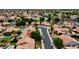 Aerial view of a well-kept neighborhood featuring tiled roofs, lush trees and private swimming pools at 1450 W Sea Haze Dr, Gilbert, AZ 85233