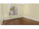 Bedroom with wood-look flooring, yellow walls and a window dressed with white curtains at 1450 W Sea Haze Dr, Gilbert, AZ 85233