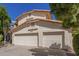 The side of the home shows the three car garage with doors and a concrete driveway at 1450 W Sea Haze Dr, Gilbert, AZ 85233