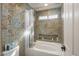 Bathroom with shower/tub combo and patterned tile at 15165 N 102Nd Way, Scottsdale, AZ 85255