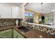 Kitchen with a large sink and view to living room at 15165 N 102Nd Way, Scottsdale, AZ 85255