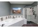 Modern bathroom featuring a soaking tub, a glass-enclosed shower, and contemporary fixtures at 15838 E Thistle Dr, Fountain Hills, AZ 85268