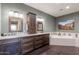 A luxury bathroom with double sinks, dark wood cabinetry, soaking tub and modern finishes at 15838 E Thistle Dr, Fountain Hills, AZ 85268