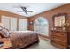 Bedroom features a ceiling fan, a large window, and a dresser with a mirror at 15838 E Thistle Dr, Fountain Hills, AZ 85268