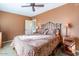 Cozy bedroom with ceiling fan, patterned bedding, and bedside tables with lamps at 15838 E Thistle Dr, Fountain Hills, AZ 85268