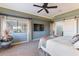 This is a nice bedroom that features large windows with a view, a TV, and a sliding door to the en-suite at 15838 E Thistle Dr, Fountain Hills, AZ 85268