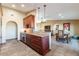 A kitchen with wooden cabinets, an island counter, and seamless flow into a dining and living area at 15838 E Thistle Dr, Fountain Hills, AZ 85268