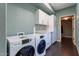 Well-equipped laundry room featuring modern washer, dryer, countertop and storage cabinets at 15838 E Thistle Dr, Fountain Hills, AZ 85268