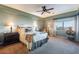 Bright main bedroom featuring a ceiling fan, en suite bath, and a large window at 15838 E Thistle Dr, Fountain Hills, AZ 85268