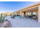 Inviting covered patio with tile flooring, desert landscaping and seating areas perfect for outdoor relaxation and entertaining at 15838 E Thistle Dr, Fountain Hills, AZ 85268