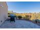 Outdoor kitchen area features a built-in grill, perfect for outdoor cooking and entertaining with a backdrop of desert landscape at 15838 E Thistle Dr, Fountain Hills, AZ 85268