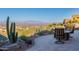 Inviting patio area with comfortable seating and desert landscaping offers a serene outdoor space for relaxing and enjoying the views at 15838 E Thistle Dr, Fountain Hills, AZ 85268