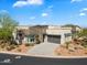 Luxury home with stone facade, driveway, and landscaped yard at 15957 E Ridgestone Dr, Fountain Hills, AZ 85268