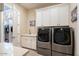 Bright laundry room features built-in cabinets, a sink, and modern washer and dryer at 15957 E Ridgestone Dr, Fountain Hills, AZ 85268