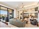 Bright living room with fireplace and sliding glass doors leading to patio at 15957 E Ridgestone Dr, Fountain Hills, AZ 85268