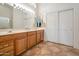 Double vanity bathroom with wood cabinets and a separate shower and tub at 15973 W Sheila Ln, Goodyear, AZ 85395