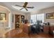 Home office with built-in wooden shelving and a large desk at 15973 W Sheila Ln, Goodyear, AZ 85395