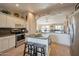 Bright kitchen featuring an island, stainless steel appliances, and white cabinetry at 15973 W Sheila Ln, Goodyear, AZ 85395