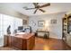 Home office featuring wood flooring and built-in shelving at 15973 W Sheila Ln, Goodyear, AZ 85395