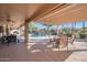 Relaxing covered patio with pool views and seating at 15973 W Sheila Ln, Goodyear, AZ 85395