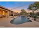 Stunning pool and patio area with a tranquil waterfall feature at 15973 W Sheila Ln, Goodyear, AZ 85395