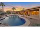 Expansive backyard oasis featuring a kidney shaped pool and patio at 15973 W Sheila Ln, Goodyear, AZ 85395