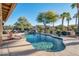 Inviting kidney-shaped pool with a surrounding patio at 15973 W Sheila Ln, Goodyear, AZ 85395