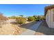 Landscaped backyard with a pathway and gravel at 16442 W Quarry Ct, Surprise, AZ 85374