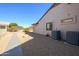 Backyard with a pathway and AC units at 16442 W Quarry Ct, Surprise, AZ 85374