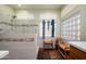 Spa-like bathroom with glass shower and wood bench at 16442 W Quarry Ct, Surprise, AZ 85374