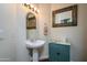 Small bathroom with pedestal sink and teal cabinet at 16442 W Quarry Ct, Surprise, AZ 85374