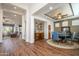 Bright dining area with hardwood floors and a round table for six at 16442 W Quarry Ct, Surprise, AZ 85374