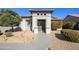 Welcoming front entry with decorative iron gate and drought-tolerant landscaping at 16442 W Quarry Ct, Surprise, AZ 85374